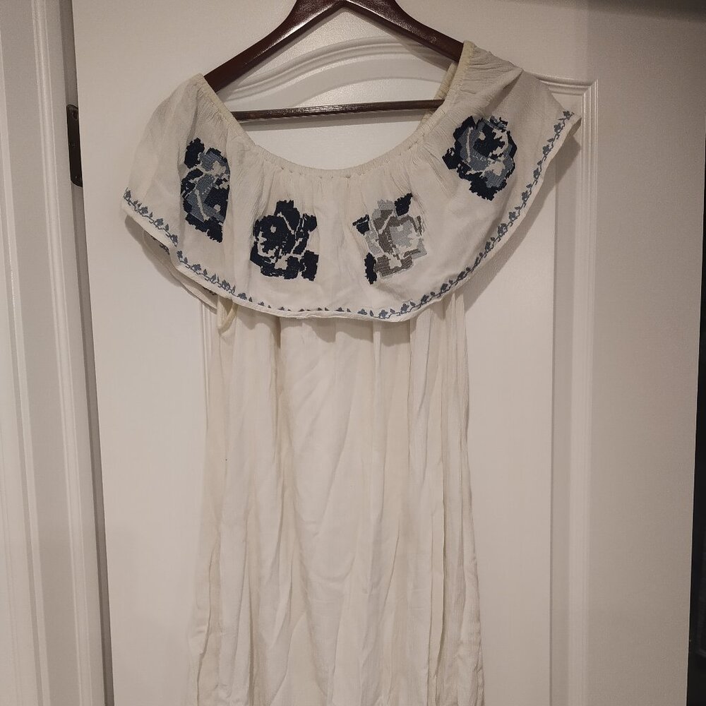 White off the shoulder dress with embroidered blue flowers